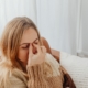 Woman dealing with sinus pressure caused by indoor allergies during winter