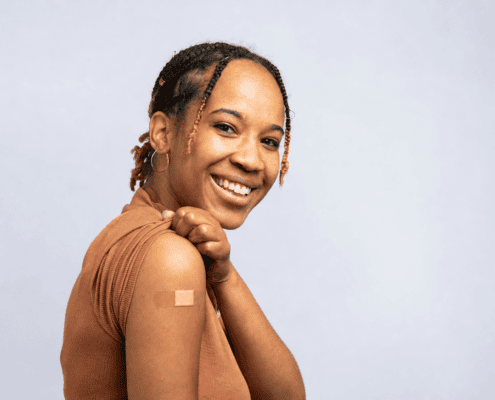 Woman smiling after receiving an allergy shot to treat her allergy symptoms