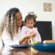 Mother feeding a young child